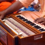 hare Krishna devotee playing harmonium